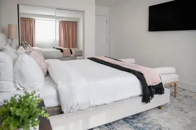 a white bedroom with a white bed and a mirror at 5 Star Private House 5 rooms in Los Angeles