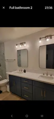 a bathroom with two sinks and a toilet and a mirror at Cheerful 4 bed, 2 bath with pool near Disneyland in Placentia