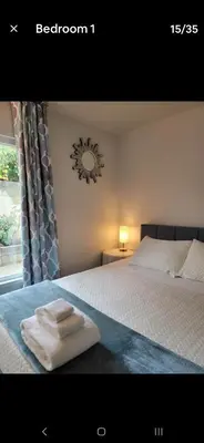a bedroom with a bed with two folded towels on it at Cheerful 4 bed, 2 bath with pool near Disneyland in Placentia