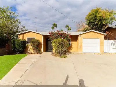 a yellow house with a white garage at Modern 4 bedroom in San Fernando in San Fernando