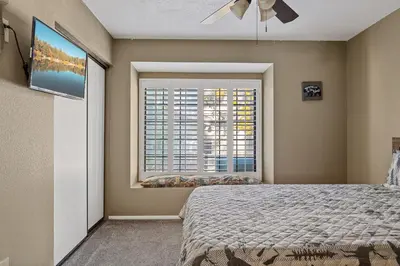 a bedroom with a bed and a window at BIg Bear G5 Getaway in Big Bear Lake