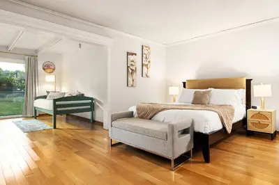 a bedroom with a bed and a chair and a window at Adorable 4 bedroom home with Pool & more in Los Angeles