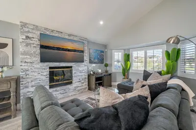 a living room with a couch and a fireplace at The Lakefront Oasis in Victorville