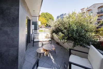 a patio with a table and chairs on a balcony at Exquisite Haven with Patio Sleeps 4 in Los Angeles