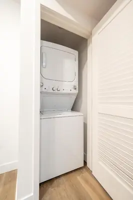 a kitchen with a washer and dryer in a closet at Exquisite Haven with Patio Sleeps 4 in Los Angeles