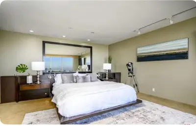 a bedroom with a large bed and a large mirror at Secluded Luxury Hollywood Hills Retreat in Los Angeles