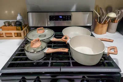 three pots and pans sitting on top of a stove at Disneyland Retreat Fun Family Unit w Game Room, King Beds & EV Friendly - Sleeps up to 14 in Midway City