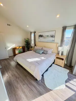 a bedroom with a large bed and a rug at Central North Hollywood Home in Los Angeles