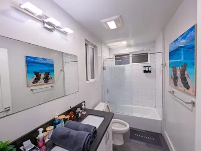 a bathroom with a sink and a toilet and a tub at Central North Hollywood Home in Los Angeles