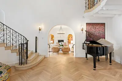a living room with a staircase and a piano at Mediterranean Dream Villa Oasis in Los Angeles