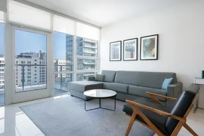 a living room with a couch and a table at Level Los Angeles - Downtown South Olive in Los Angeles