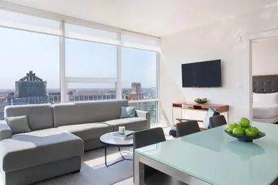 a living room with a couch and a table at Level Los Angeles - Downtown South Olive in Los Angeles