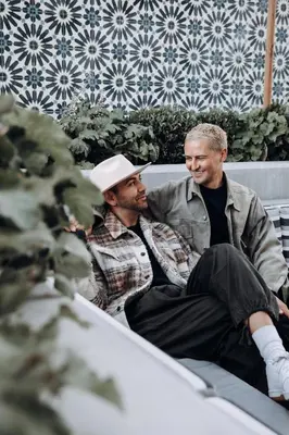 two men sitting next to each other on a bench at Level Los Angeles - Downtown South Olive in Los Angeles