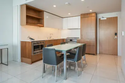 a kitchen with a table and chairs in it at Level Los Angeles - Downtown South Olive in Los Angeles