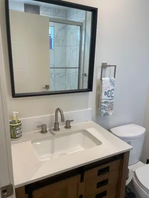 a bathroom with a sink and a mirror at New Luxe 3B 3Bath Townhouse in Sherman Oaks