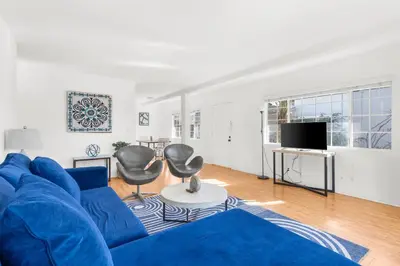 a living room with a blue couch and two chairs at Modern Furnished 2 Bedroom in West LA in Los Angeles