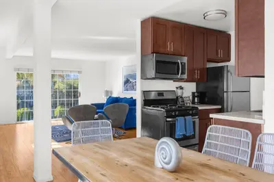 a kitchen and living room with a table and chairs at Modern Furnished 2 Bedroom in West LA in Los Angeles