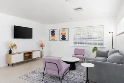 a living room with a couch and a table and chairs at 3 bedroom near Culver City-Palms in Los Angeles