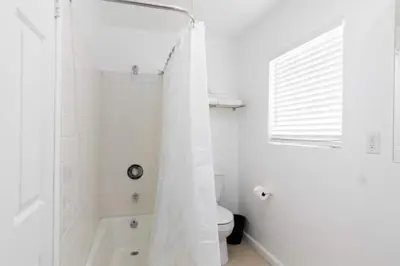 a white bathroom with a shower and a toilet at 3 bedroom near Culver City-Palms in Los Angeles
