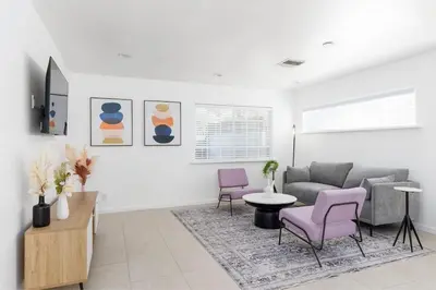 a living room with a couch and chairs at 3 bedroom near Culver City-Palms in Los Angeles