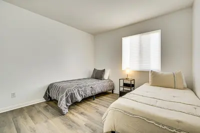 a bedroom with two beds and a window at Pool Table and Charcoal Grill Home in Victorville! in Victorville