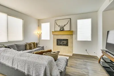 a living room with a couch and a fireplace at Pool Table and Charcoal Grill Home in Victorville! in Victorville