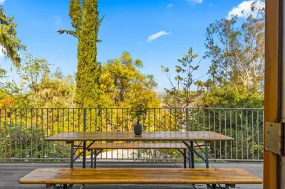 a picnic table on a deck with a fence at Peaceful Tranquility w Nature in Los Angeles