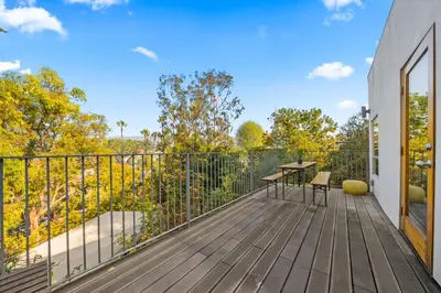 a wooden deck with a table and chairs on it at Peaceful Tranquility w Nature in Los Angeles