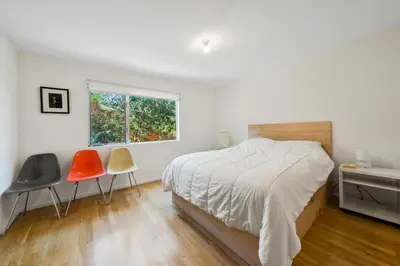 a bedroom with two chairs and a bed and a window at Peaceful Tranquility w Nature in Los Angeles