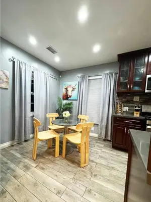 a dining room with a table and chairs and a kitchen at Charming 2BR Spot Near LAX, SoFi and Forum - MK1-LAD in Los Angeles