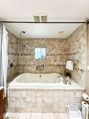 a bath tub in a bathroom with a tiled wall at Charming 2BR Spot Near LAX, SoFi and Forum - MK1-LAD in Los Angeles