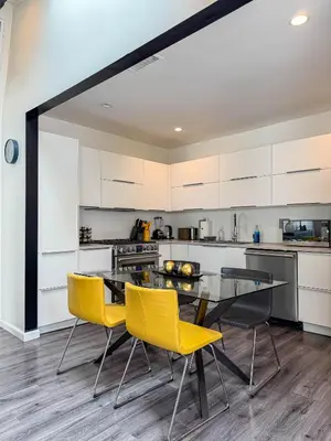 a kitchen with a glass table and yellow chairs at Perfect 1-BR Spot Near LAX, SoFi and Forum - MK2-LAD in Los Angeles