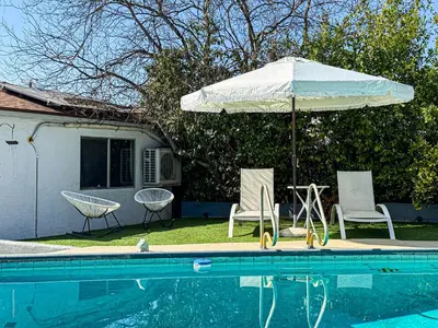 a pool with an umbrella and two chairs and a table with an umbrella at Perfect 1-BR Spot Near LAX, SoFi and Forum - MK2-LAD in Los Angeles
