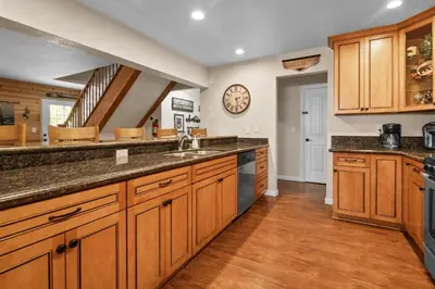 a large kitchen with wooden cabinets and a sink at Eagle Point Retreat - Sleeps 13 - 12 Adults Max, Game Room, Foosball, Fireplace, Deck, Barbecue in Big Bear Lake