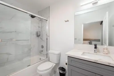 a bathroom with a toilet and a sink and a shower at Stunning 3-BR Residence with Free Parking & Patio in Los Angeles