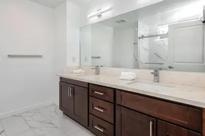 a bathroom with a sink and a large mirror at Luxury 2BR Stay Balcony Views and Free Parking in Los Angeles