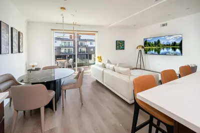 a living room with a couch and a table at Experience Lavish LA Living Sleek 2BR with Parking in Los Angeles