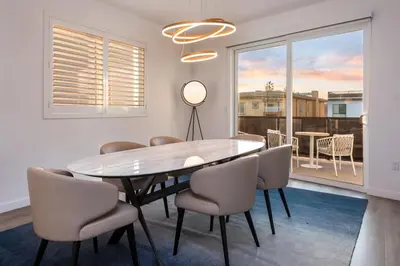 a dining room with a table and chairs and a window at Ultimate Luxurious Penthouse with Private Balcony in Los Angeles