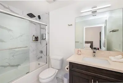 a bathroom with a toilet and a shower and a sink at Ultimate Luxurious Penthouse with Private Balcony in Los Angeles