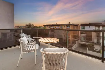 a balcony with a table and chairs on a balcony at Ultimate Luxurious Penthouse with Private Balcony in Los Angeles