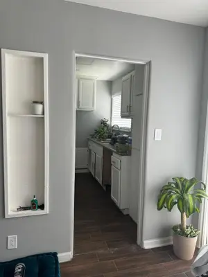 a kitchen with white cabinets and a potted plant at Hollywood escape in Los Angeles