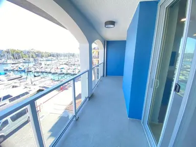a balcony with a view of a marina with boats at Modern Marina Escape with Harbor Views in Los Angeles