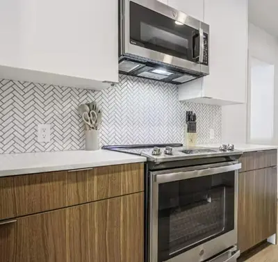 a kitchen with a stove and a microwave at Modern Marina Escape with Harbor Views in Los Angeles
