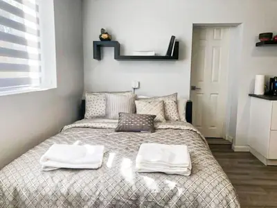a bedroom with a bed with towels on it at Cozy LA Studio Steps from SoFi and LAX - SH3 - LAD in Los Angeles