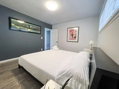 a bedroom with a large white bed and a window at Bright 2-BR Home Near LAX with Shared Yard - SH2-LAD in Los Angeles