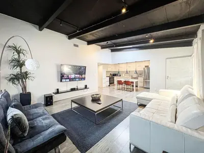 a living room with a white couch and a table at Bright 2-BR Home Near LAX with Shared Yard - SH2-LAD in Los Angeles