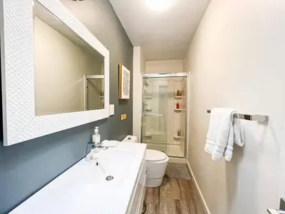 a bathroom with a sink and a toilet and a mirror at Bright 2-BR Home Near LAX with Shared Yard - SH2-LAD in Los Angeles