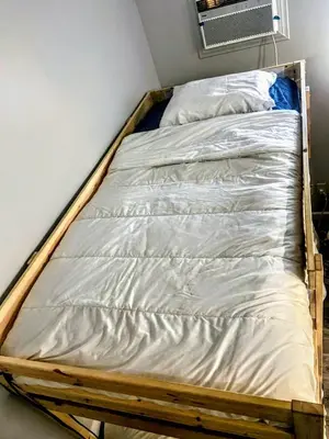 a bed frame in a corner of a room at Homes for Soul Los Angeles in Los Angeles