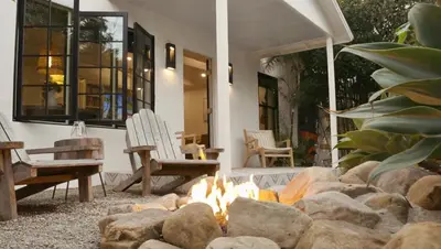 a fire pit in the middle of a patio with two chairs at Channel Islands Beach Retreat in Oxnard