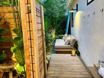 a wooden door leading to a patio with a bench at Channel Islands Beach Retreat in Oxnard
